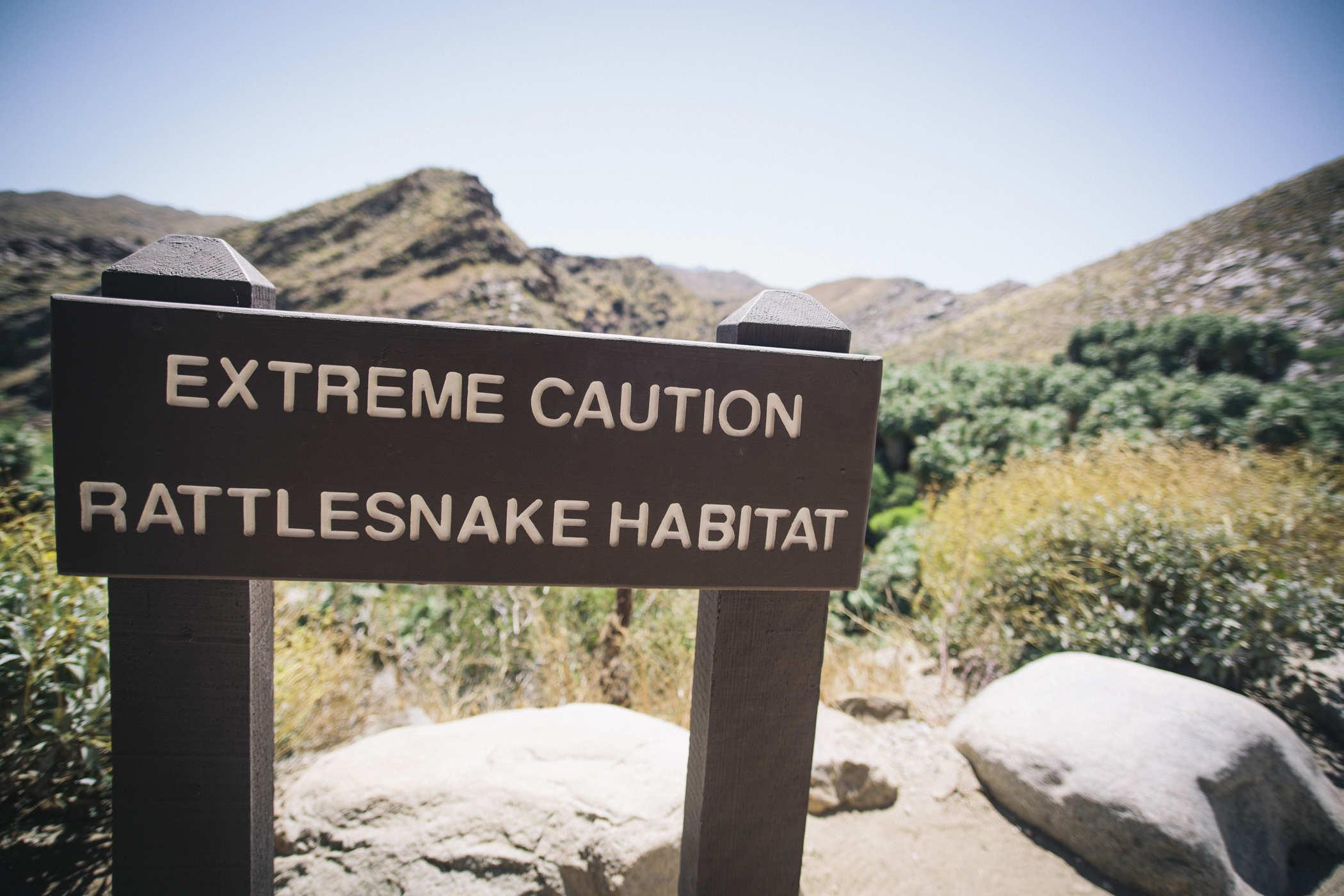 Photo of a sign that reads 'EXTREME CAUTION - RATTKESNAKE HABITAT