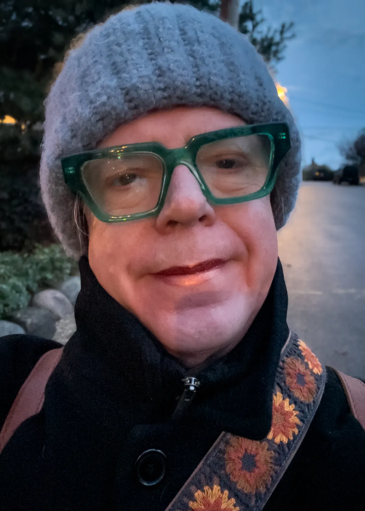 selfie with burnt orange lipstick and blue knit cap 20251116-IMG_8340