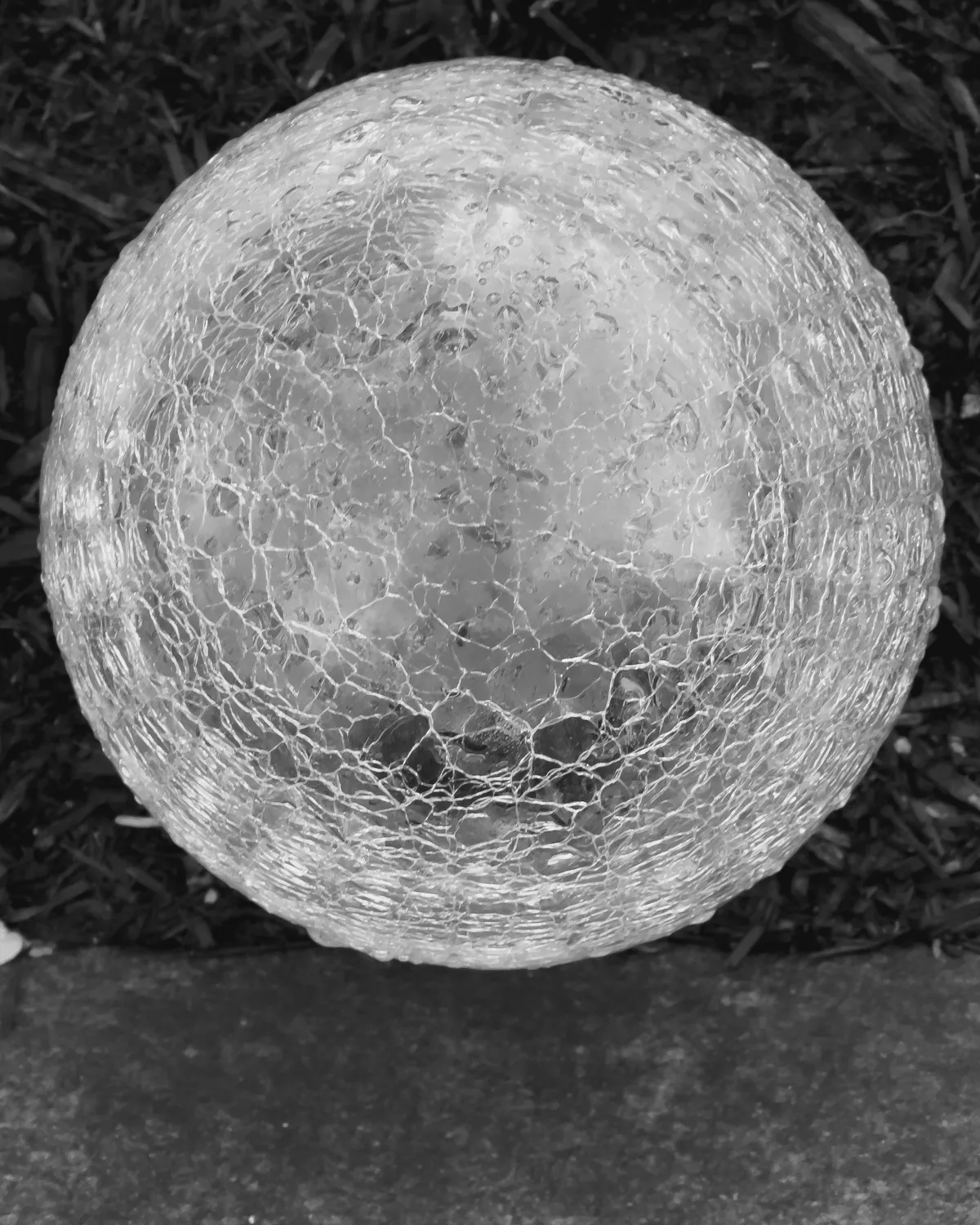 krinkled glass sphere on a dark background 20251116-IMG_8372