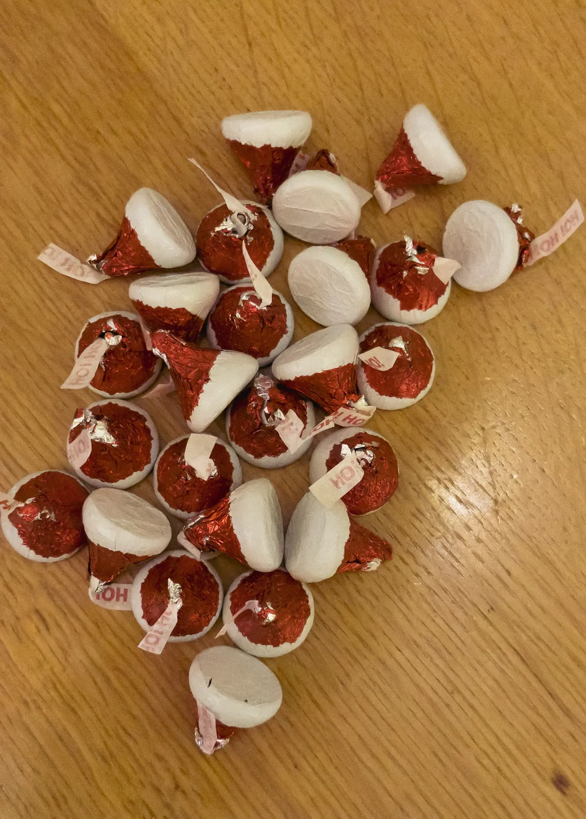 pile of santa's hat hershey's kisses lying on a wooden table 20251215-IMG_9884
