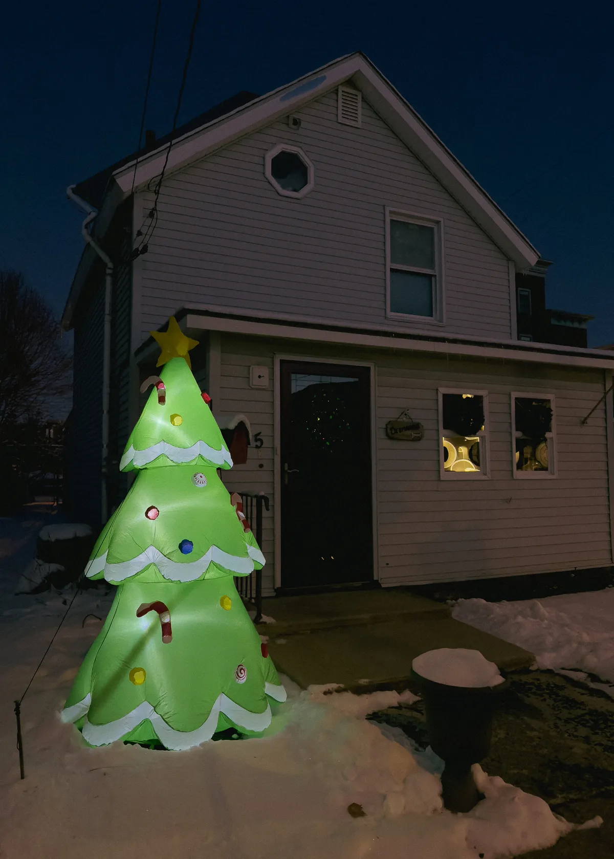 inflatable christmas tree decoration in front of a house 20251215-IMG_9905