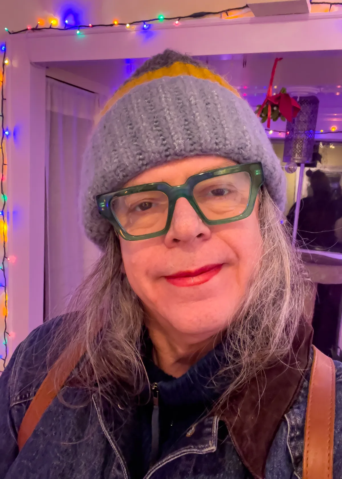 head shot of trans person with colorful knit cap IMG_7149