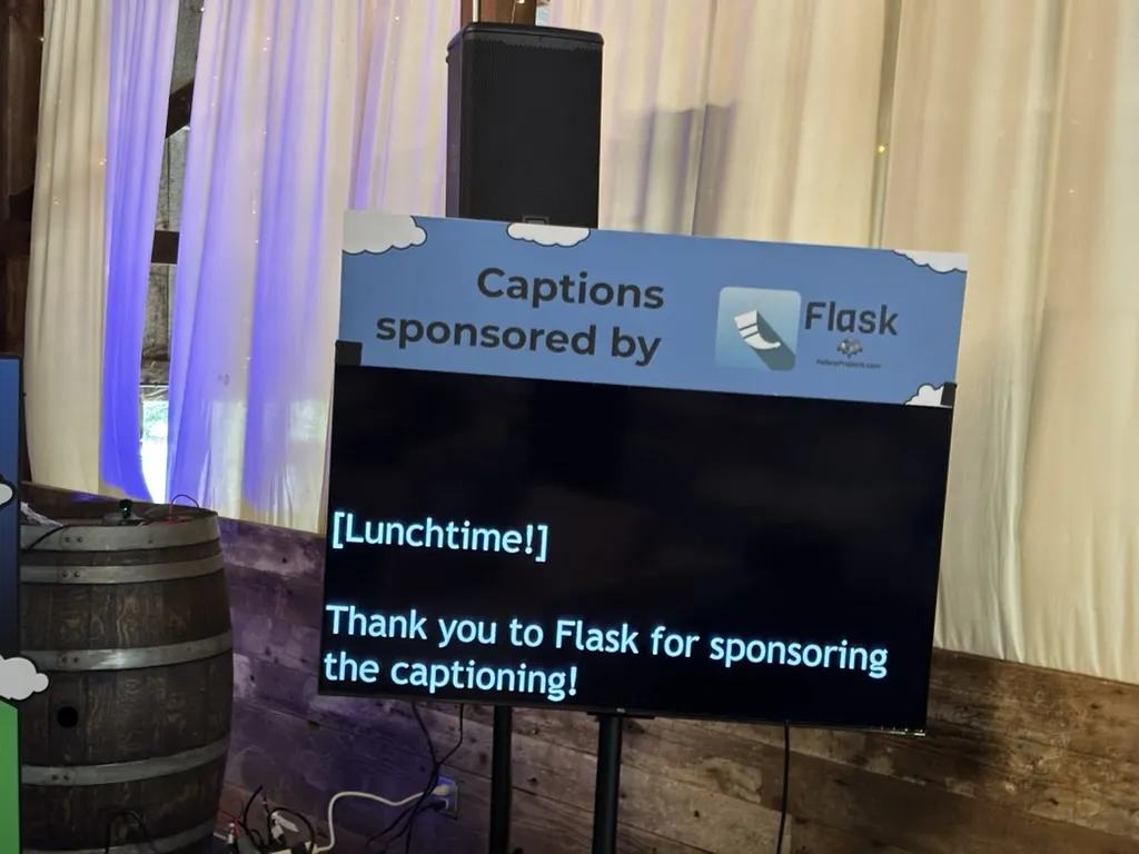A banner above the live caption screen, saying Captions sponsored by Flask