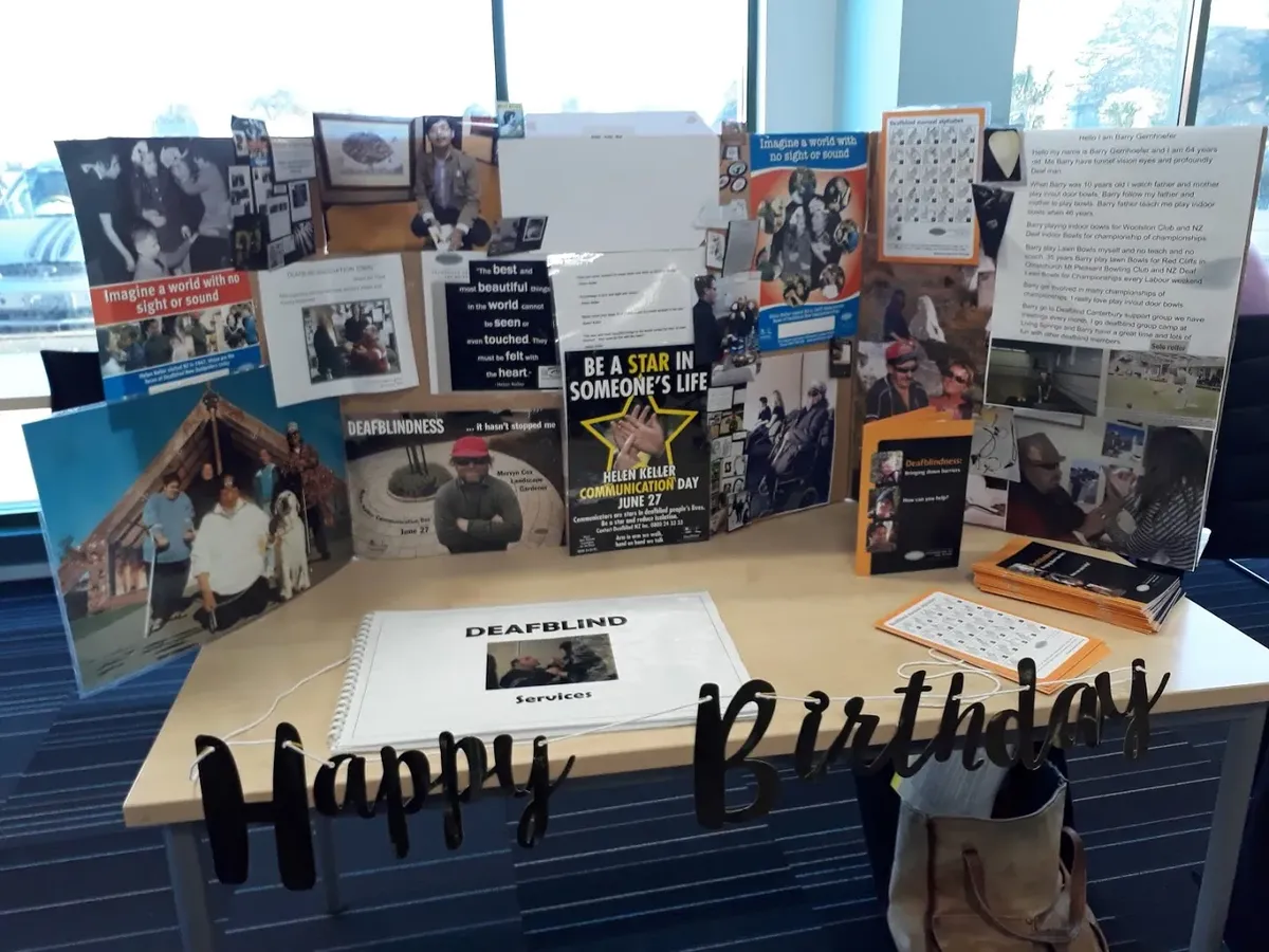 Posters and books on table in Papanui Library, with truffles and balloons