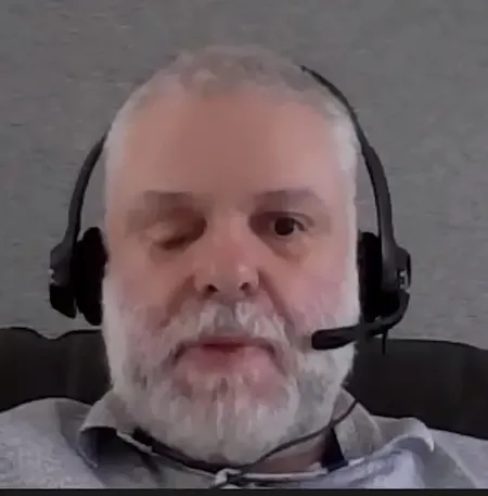 Screenshot of Vaughan wearing a headset during an online Board meeting.