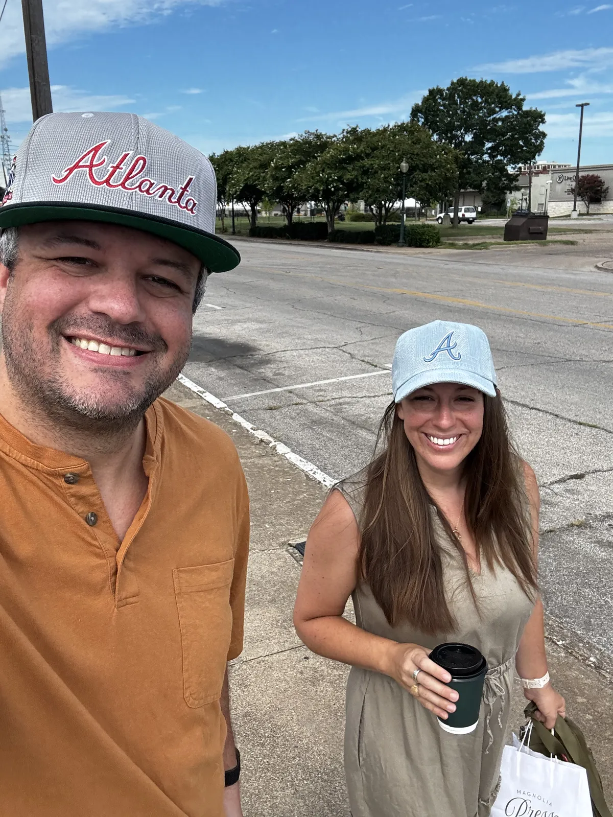 Matt and Kalena walk along a street in Waco, TX. Taken as a selfie.