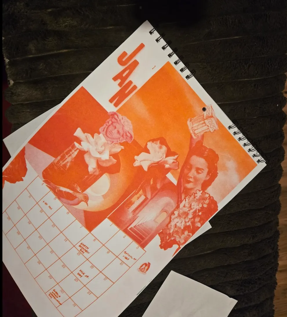 A finished calendar wire-bound and with a hold punch in the center top.