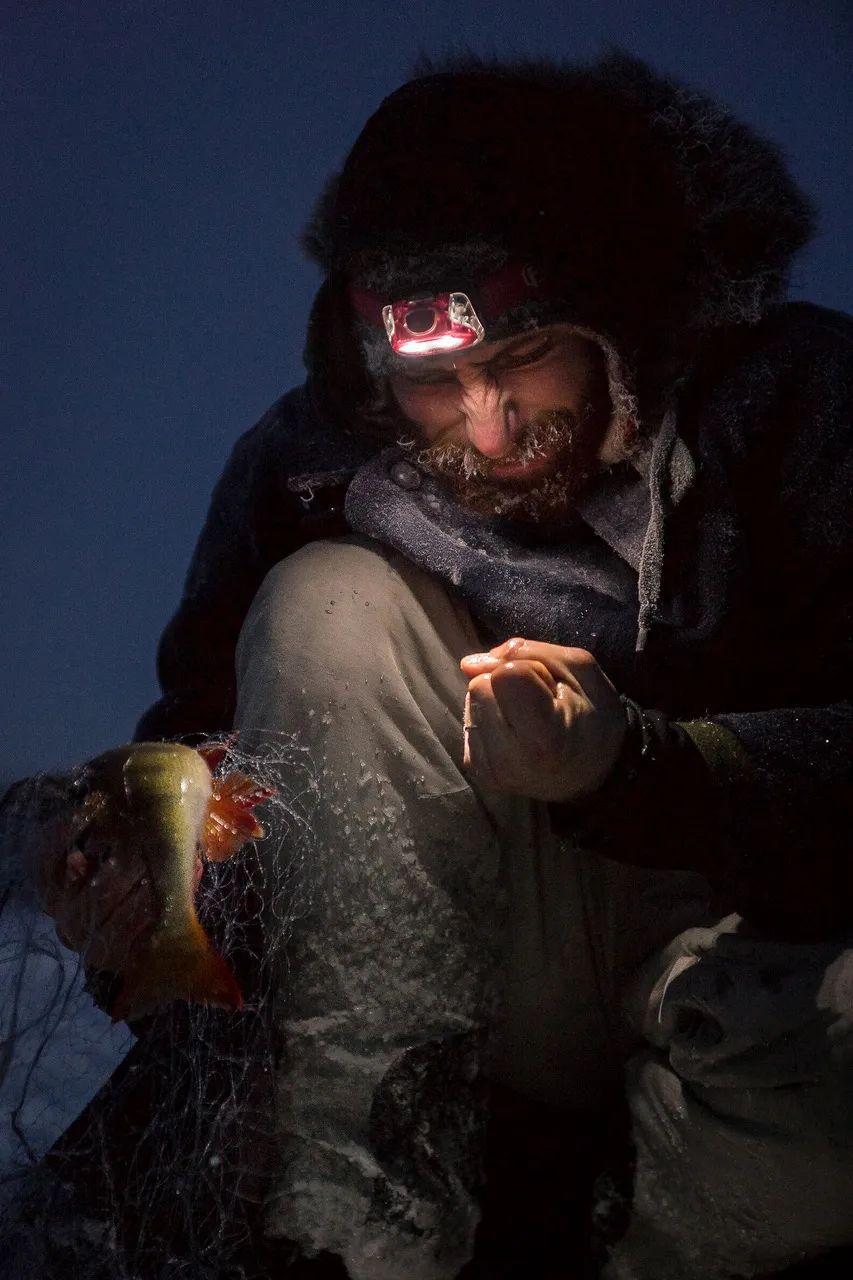 Ice fishing on a frozen lake in Lapland – survival and self-sufficiency in the tundra