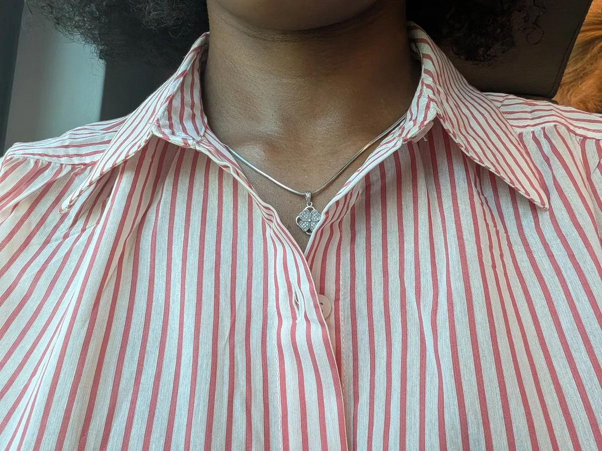 the blogger is wearing a collared button-down with red and white stripes.