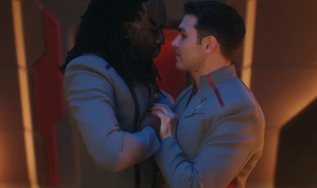 Darem and Jay-Den standing so close they're touching, hands clasped; they are staring into each other's eyes