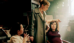 Gif of Rachael Stirling as Millie eating a biscuit