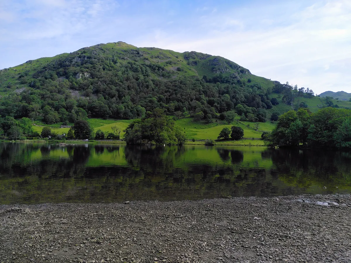 Reflection of hill and trees in a lake