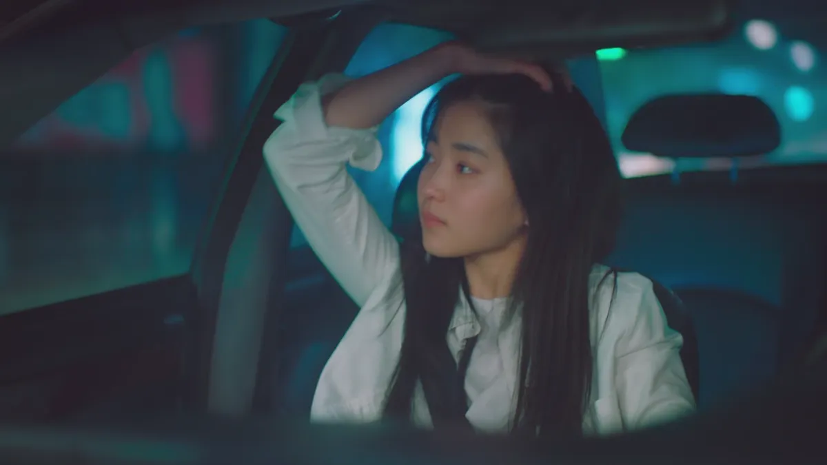 Adult Hee Do being attractive in a car at night.