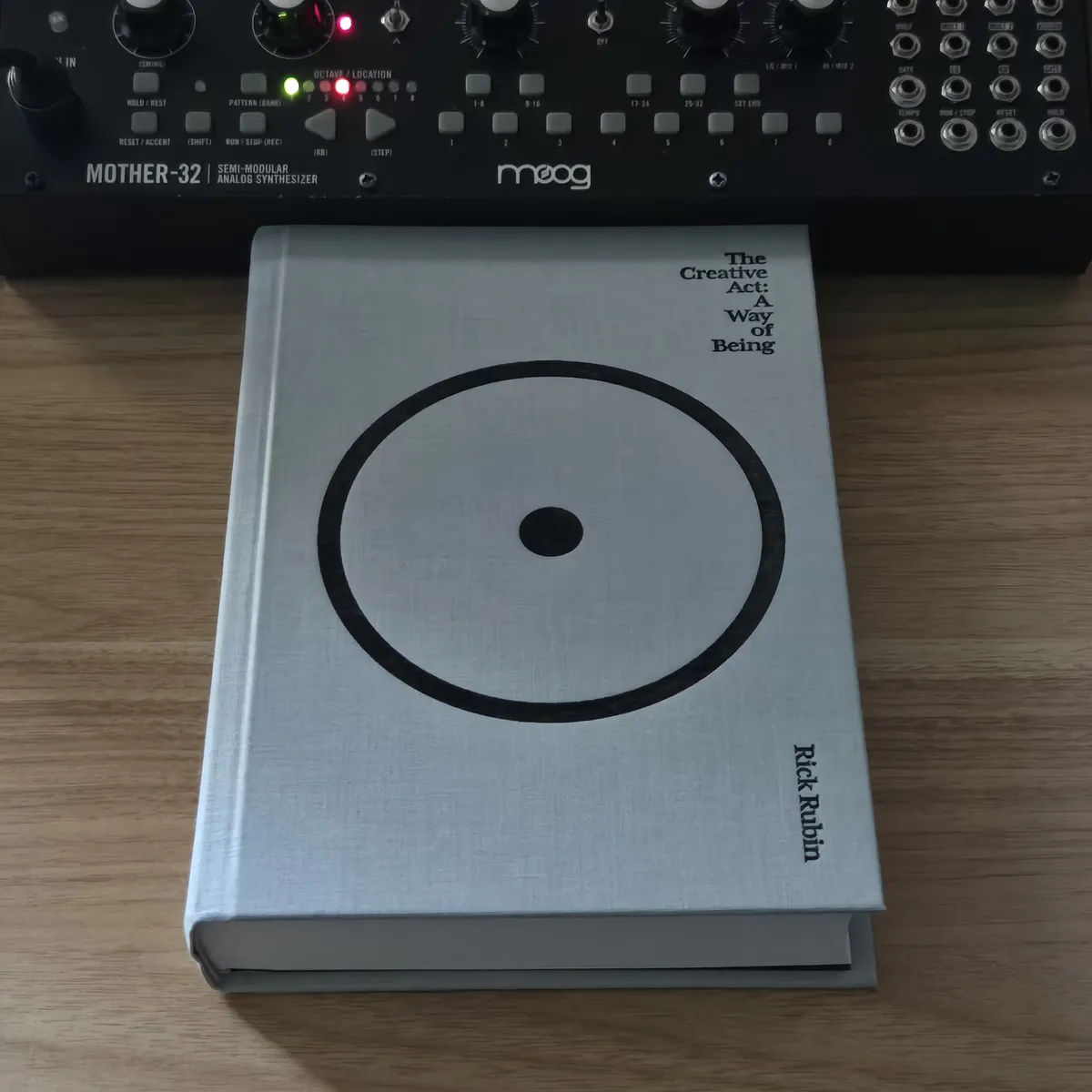 An image of Rick Rubin's book The Creative Act in front of a Moog Mother-32 synthesizer.