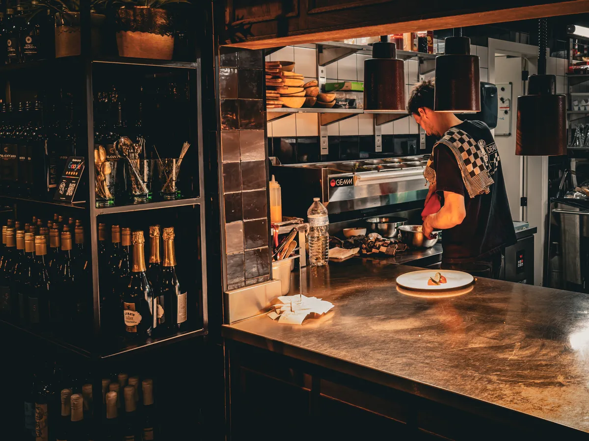 A cook in a restaurant kitchen