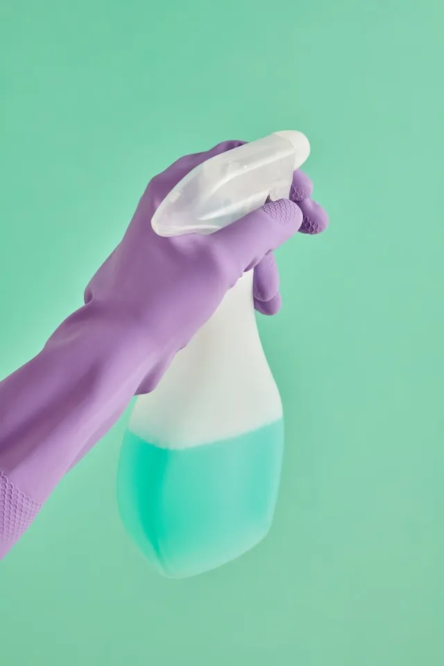 “gloved-hand-holding-a-spray-bottle"
