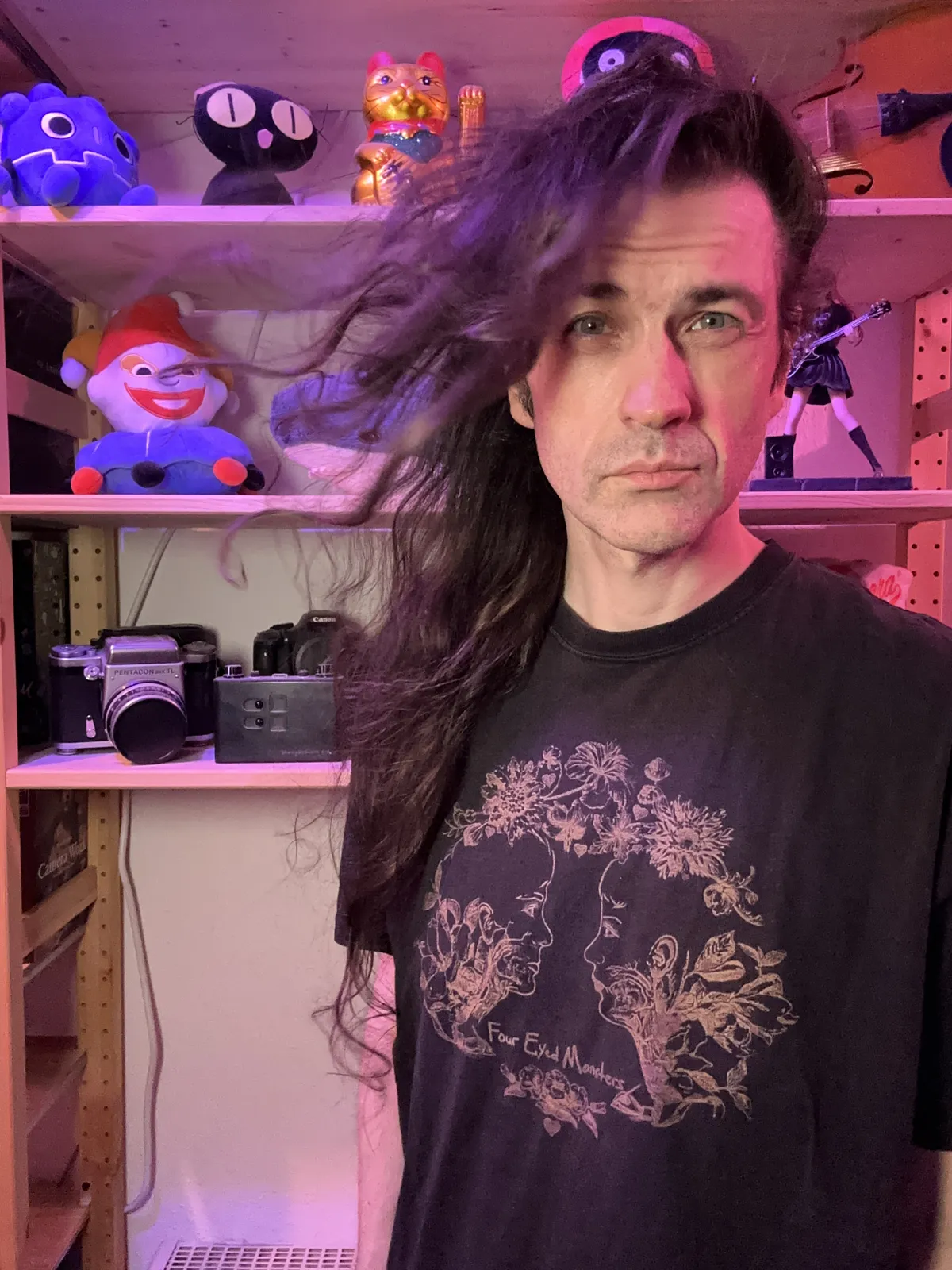 Some middle aged white dude with hair that has been growing for 2001 days and is blowing in the wind. But wait, this is indoors?!