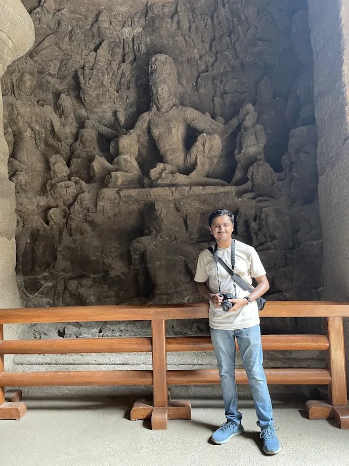 Posing for a photo near a Shiva carving
