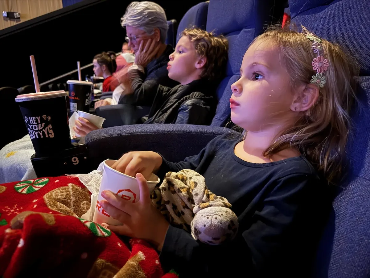 Two children sitting in a movie theater