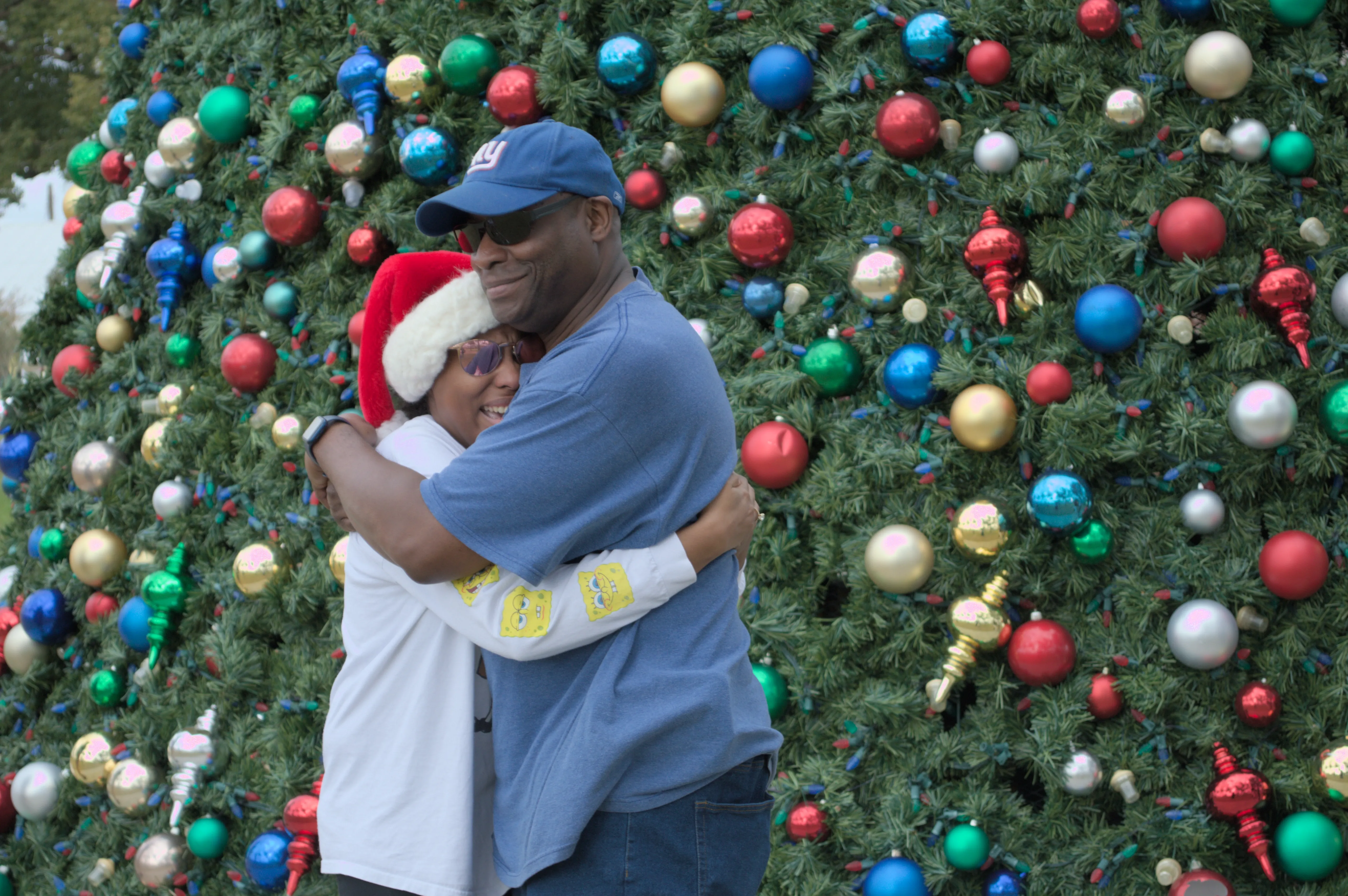 Amaya and her dad, Blayne, embrace. Both of them are smiling, as it's been over a year since they've seen each other, nor was she expecting him to be there.