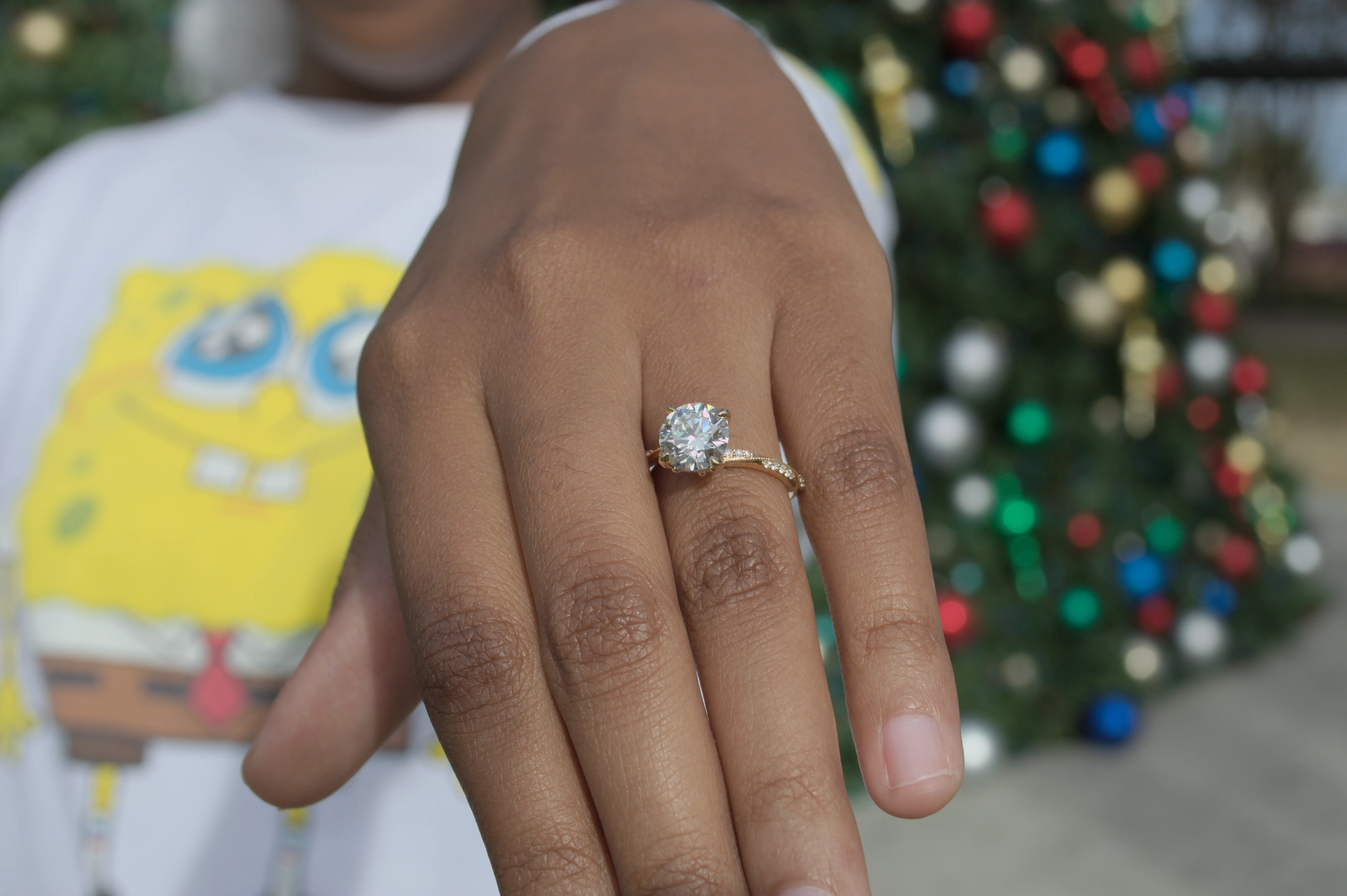 The engagement ring on Amaya's finger. The background is blurred and yet SpongeBob is clear as day.