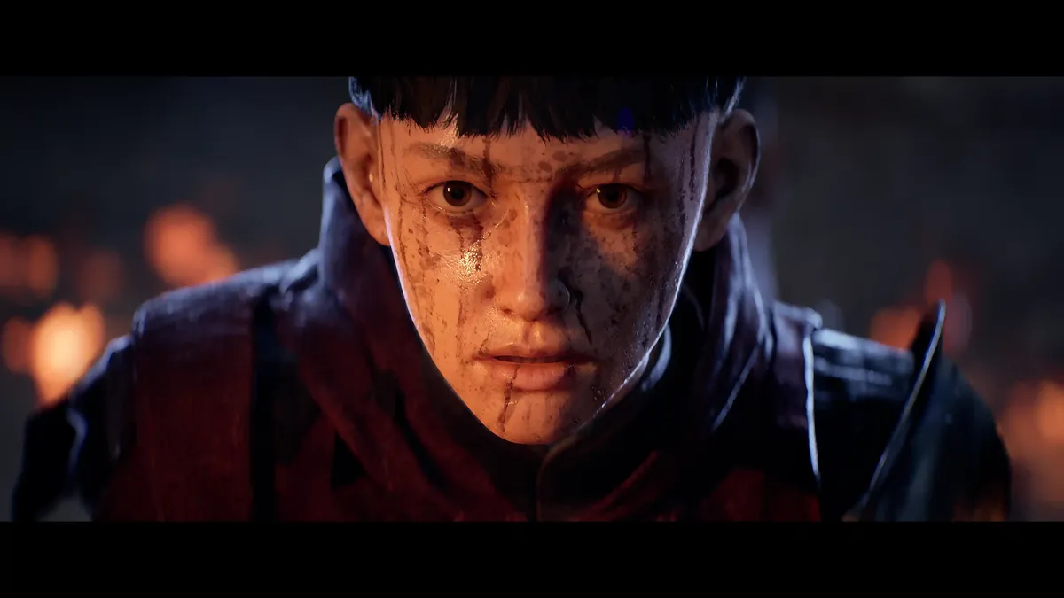A screenshot from the ending cutscene of the demo; a close-up of Aeta's face, covered in sweat, dirt, and blood. She has black hair in the sort bowl-cut of a knight in training, and intense brown eyes. Behind her, a building burns.