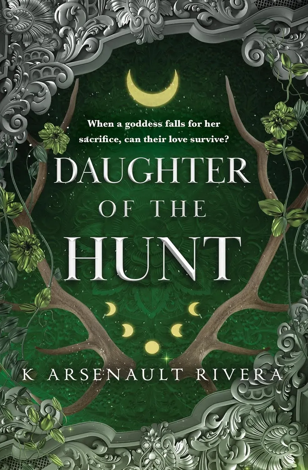 The cover of Daughter of the Hunt, by K Arsenault Rivera is framed by metal filigree against a green, mandala-like background. Green vines hang in front of a pair of deer antlers, between which are nestled five moon phases, with a bottom-heavy crescent moon topping the page.