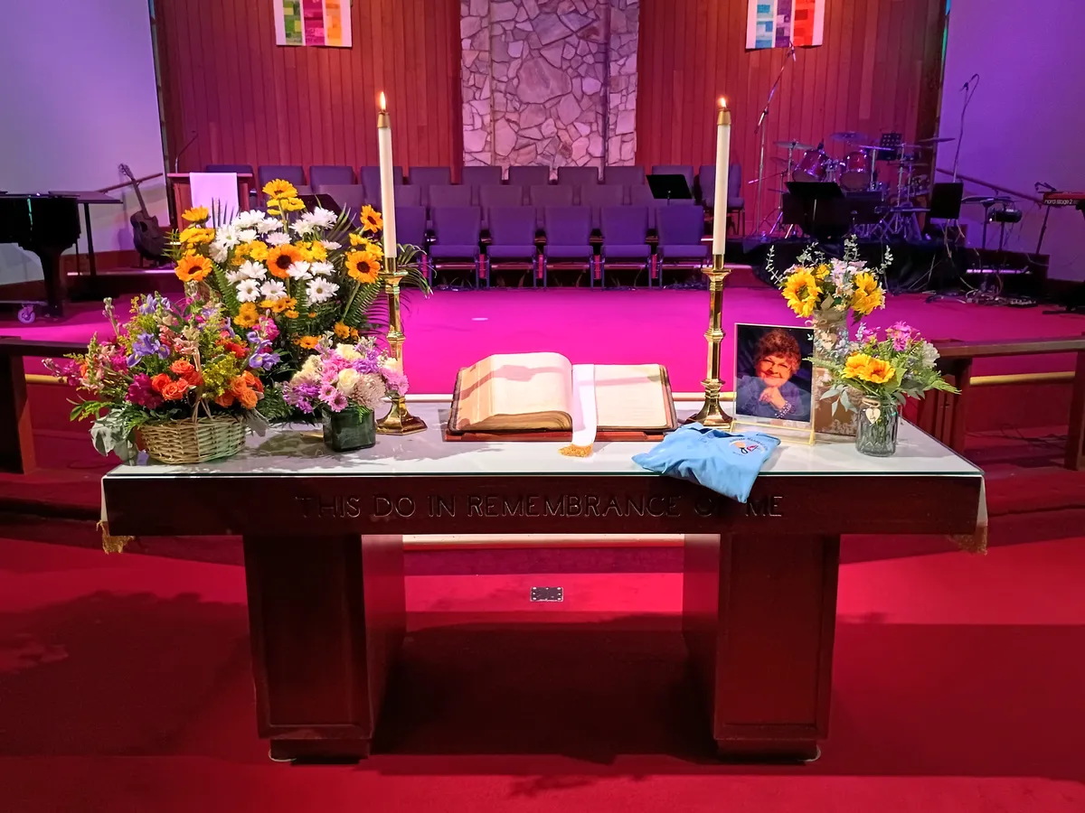 memorial altar arrangement with flowers and photographs