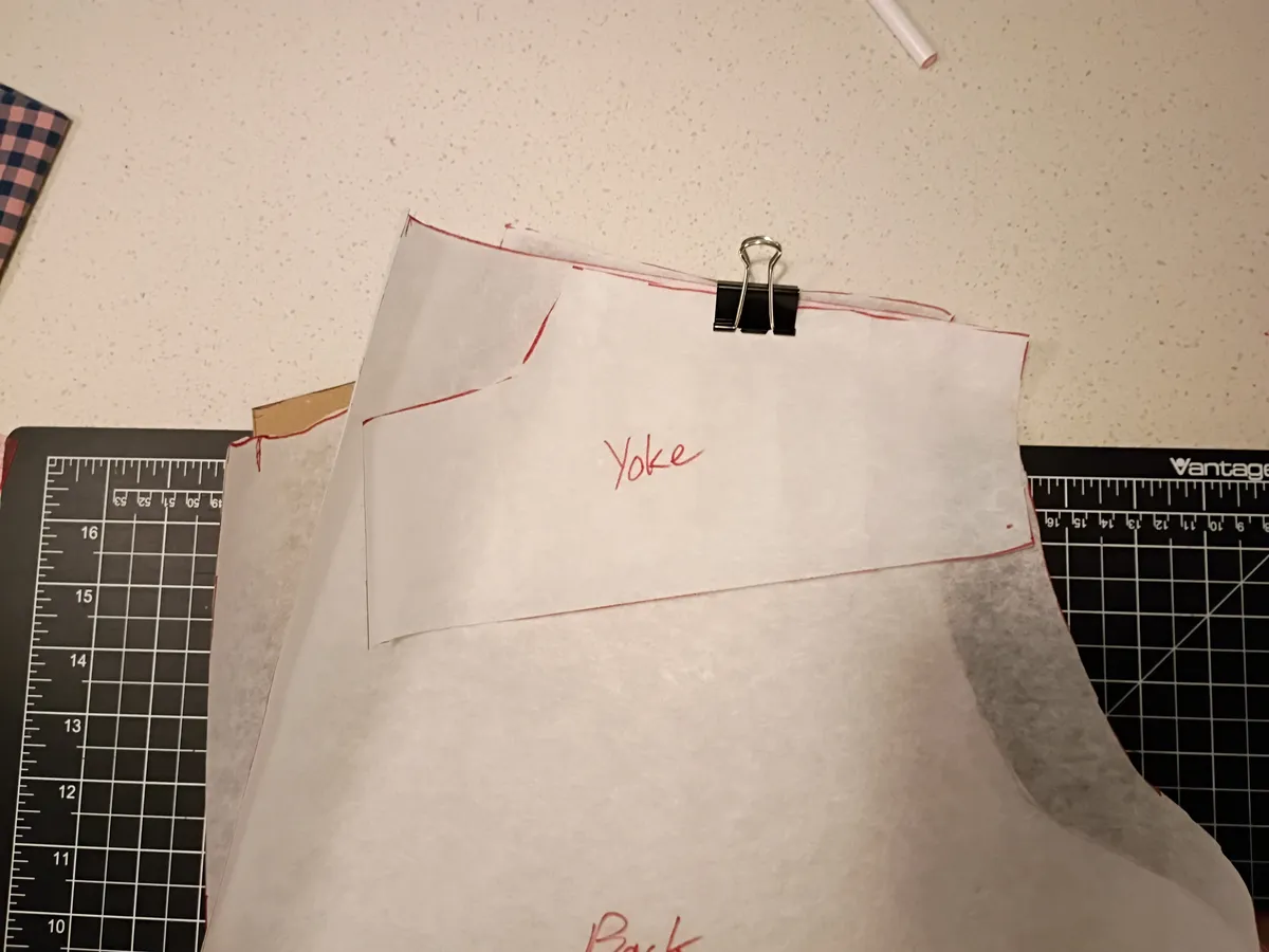 self-drafted shirt patterns in tracing paper and brown construction paper