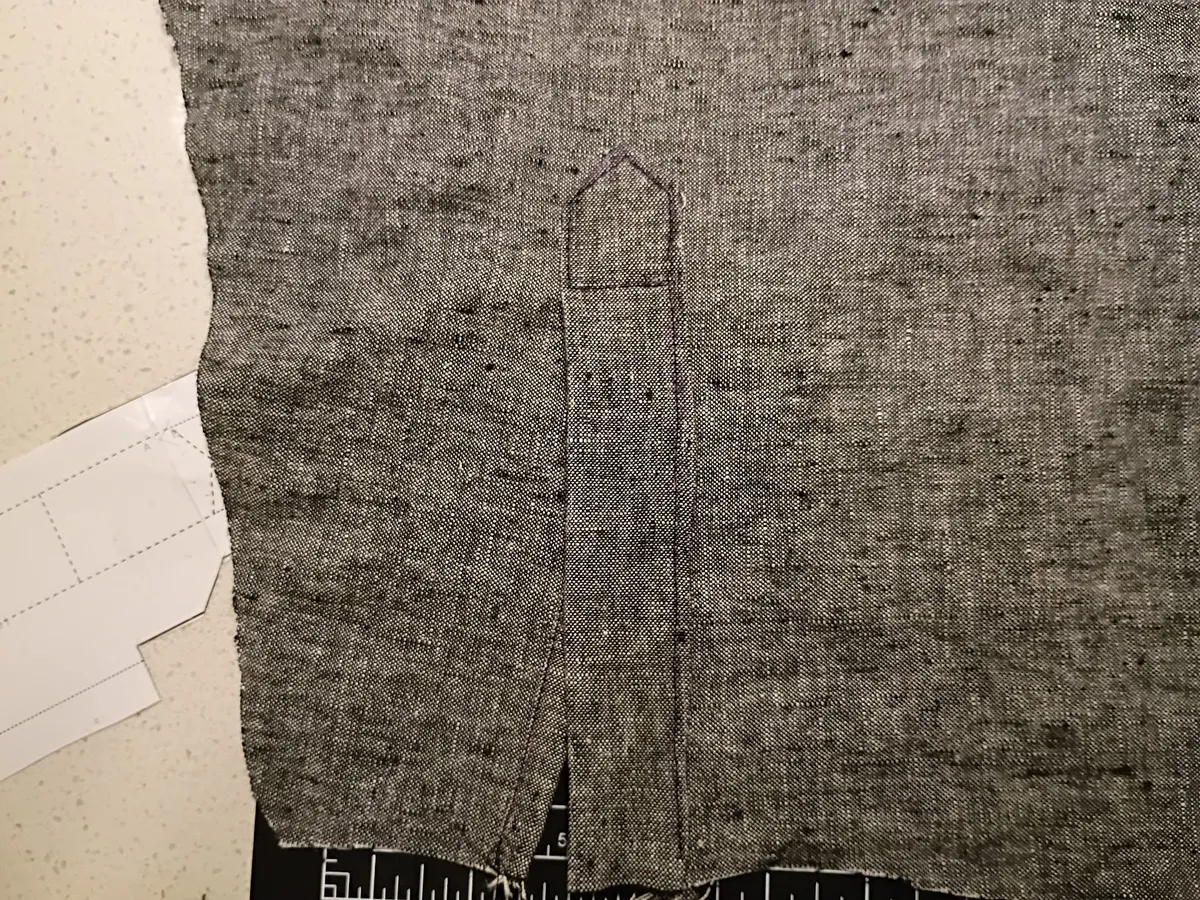 detail photograph of a sleeve placket on grey fabric