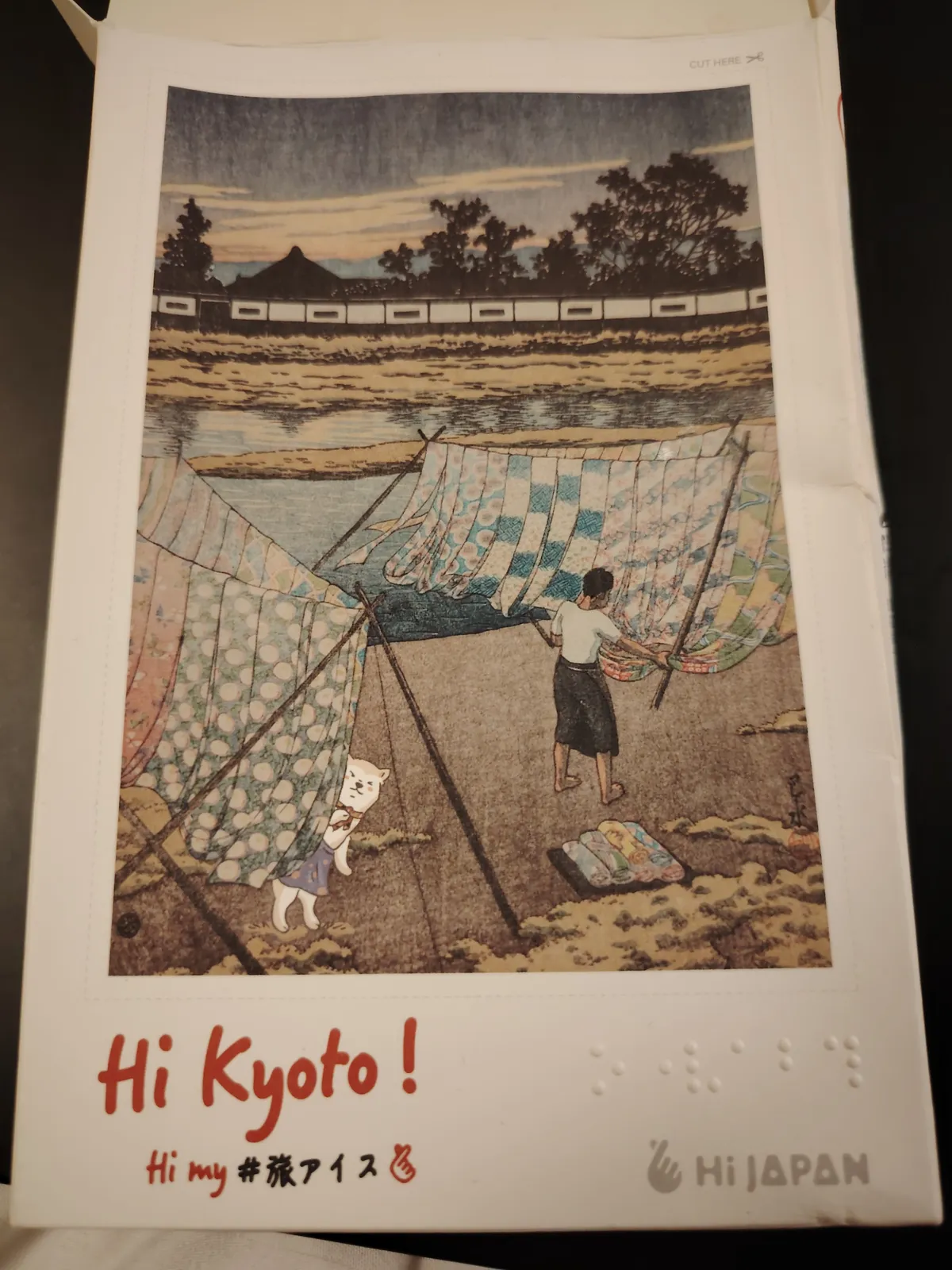 The packaging of the ice cream fan. It's an old timey drawing of a japanese person doing laundry by a river.