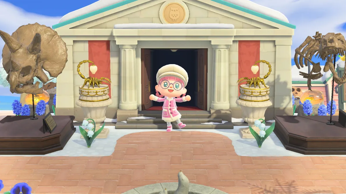 Slothra is standing in front of her museum, with has a triceratops skull, a tyrannosaurus rex skull and torso, and two scorpion lights on plinths
