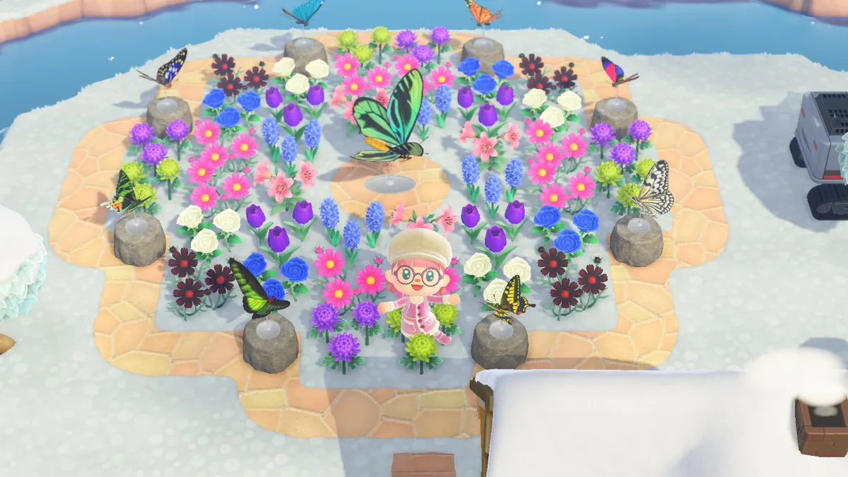 Slothra is surrounded by flowers in a circular shape, with statues of butterflies arranged around them