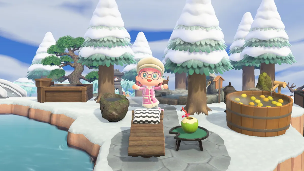 Slothra stands next to a yuzu-filled hot tub, with a lounger in front of them, and a wooden hot tub and a stone hot spring behind them.