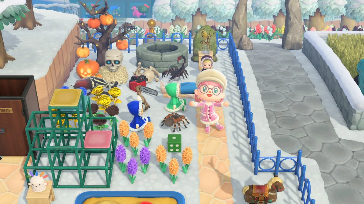 Slothra stands towards the back of the theme park, with a jungle gym, a pony riding toy, a bunch of spooky dolls, a tarantula, a chainsaw, a tree covered in jack-o-lanterns, a scorpion, a tombstone, and a dark and threatening well