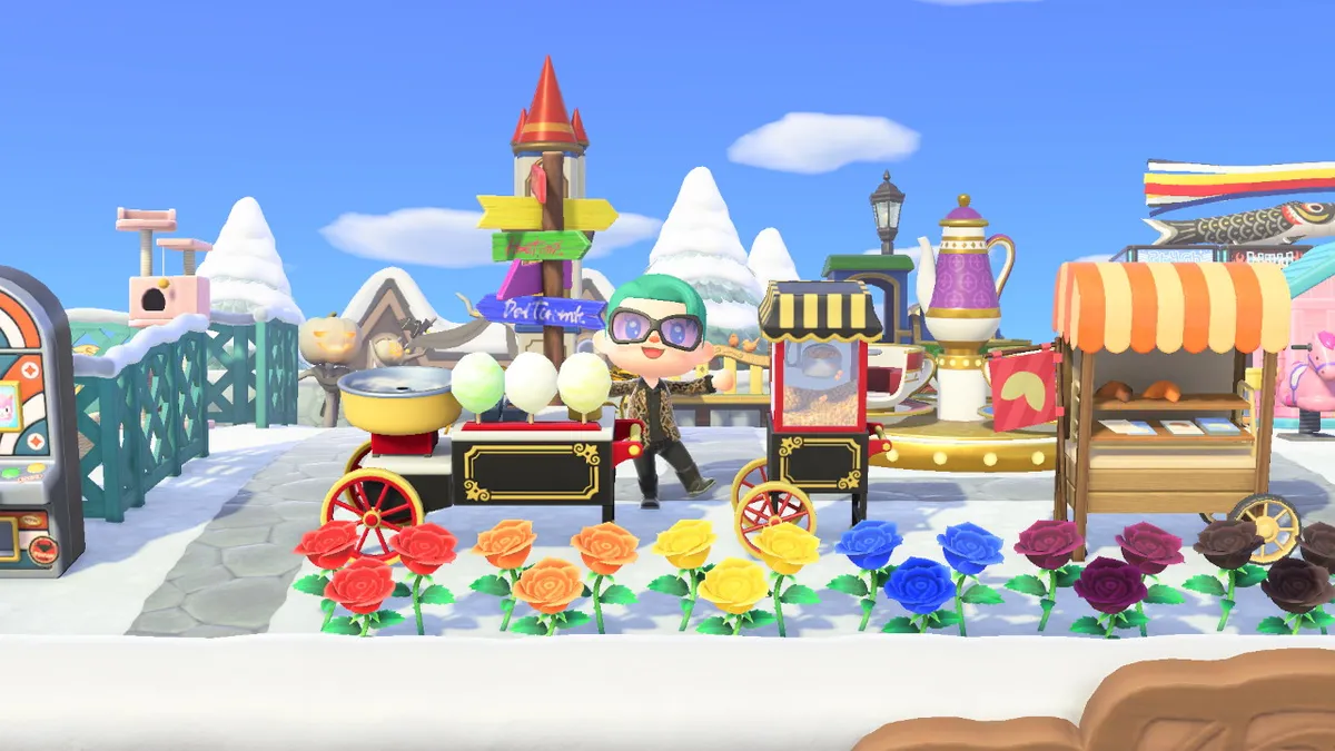 Slothra is standing behind a line of colourful roses, a cotton candy machine, a popcorn machine, and a fortune cookie stall.