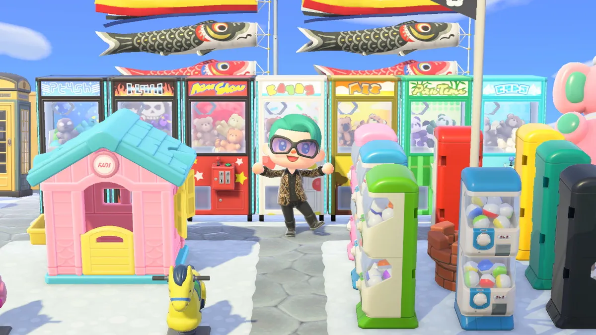 Slothra is standing in front of a row of seven crane machines, with carp streamers behind the machines. To the right is a selection of eight gachapon machines, arranged in a square.