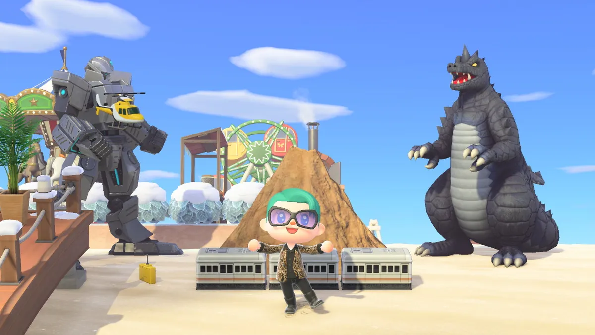 Slothra stands in front of a large volcano. In front of the volcano, there's a small passenger train. To the left of the volcano is a large silver Gundam. To the right of the volcano is Godzilla. And there's a toy helicopter in the air up by the Gundam.