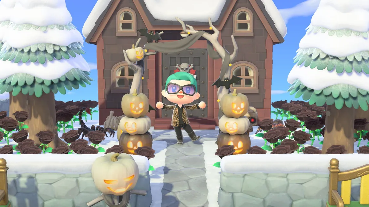 Slothra is standing in front of a dark house. There are stacks of jack-o-lanterns and black roses around them.