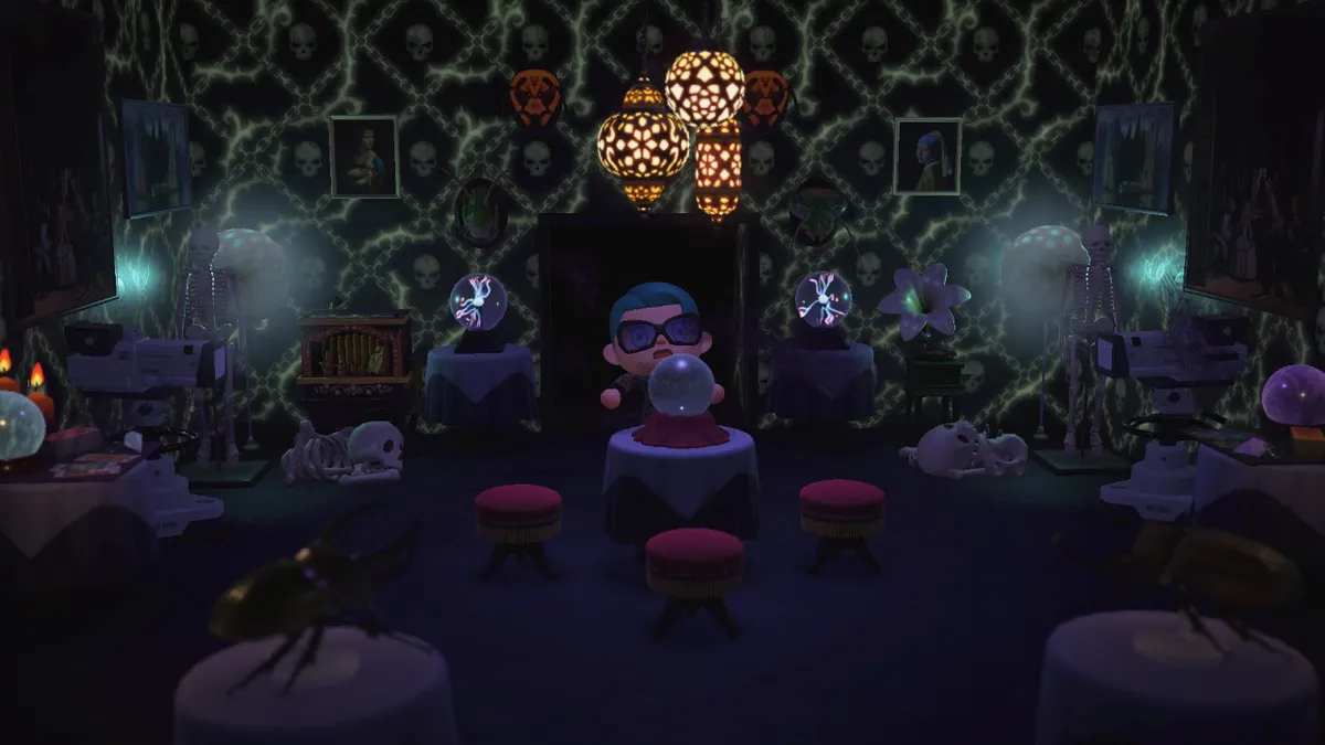 Slothra stands behind a table with a crystal ball on top. Around them are skeletons, glowing orbs, plasma balls, and other spooky materials.