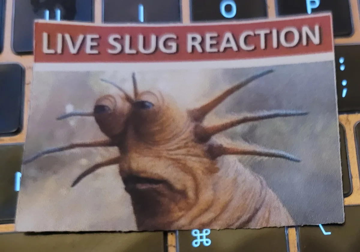 Klaud, the Trodatome who is part of the Resistance in Star Wars: The Rise of Skywalker, is looking towards something not in the shot. Above him is the text "Live Slug Reaction".