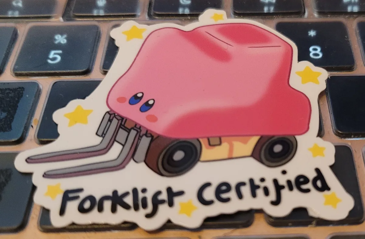 Kirby has swallowed a forklift. The text underneath says "forklift certified", which Kirby now is because he has all the power of a forklift.