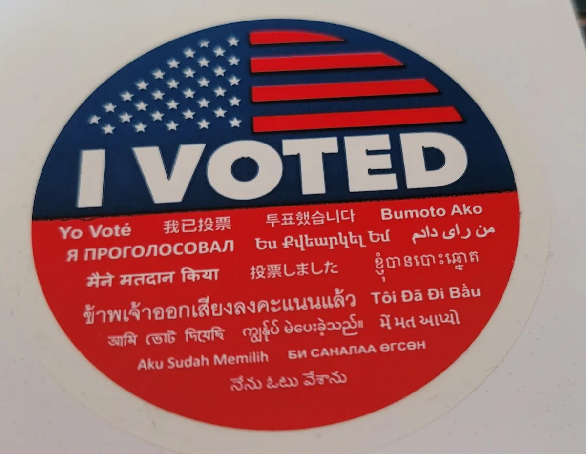 The California "I Voted" sticker, which says "I voted" in 19 languages: English, Spanish, Simplified Chinese, Korean, Tagalog, Russian, Armenian, Arabic, Hindi, Japanese, Khmer, Thai, Vietnamese, Bengali, Burmese, Gujarati, Indonesian, Mongolian, and Telugu