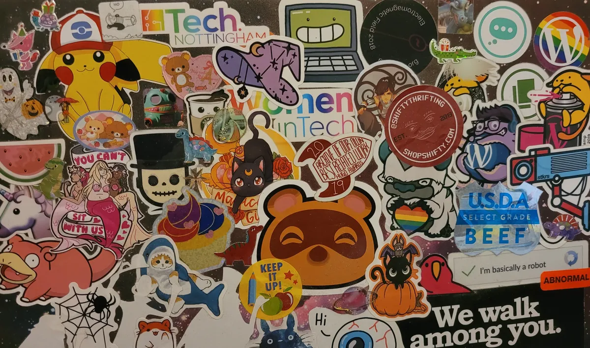 The back of a laptop case that is absolutely COVERED in stickers, including several from pop culture media sources, some programming/development references, and so much more.
