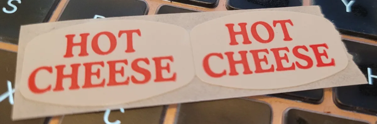Two oval stickers next to each other, both of which say