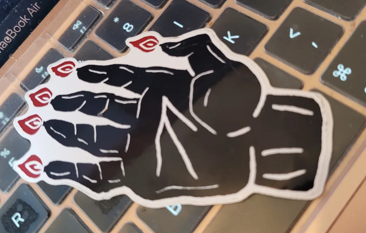 A linocut illustration of a Hand of Glory, with all the fingers lit.