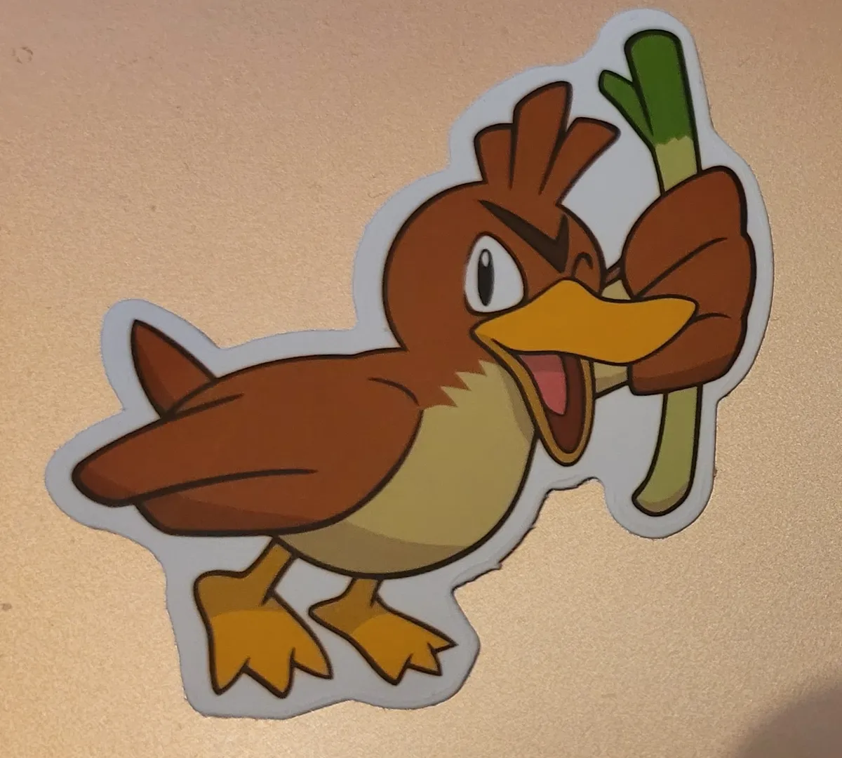 A Farfetch'd holding up its leek and winking