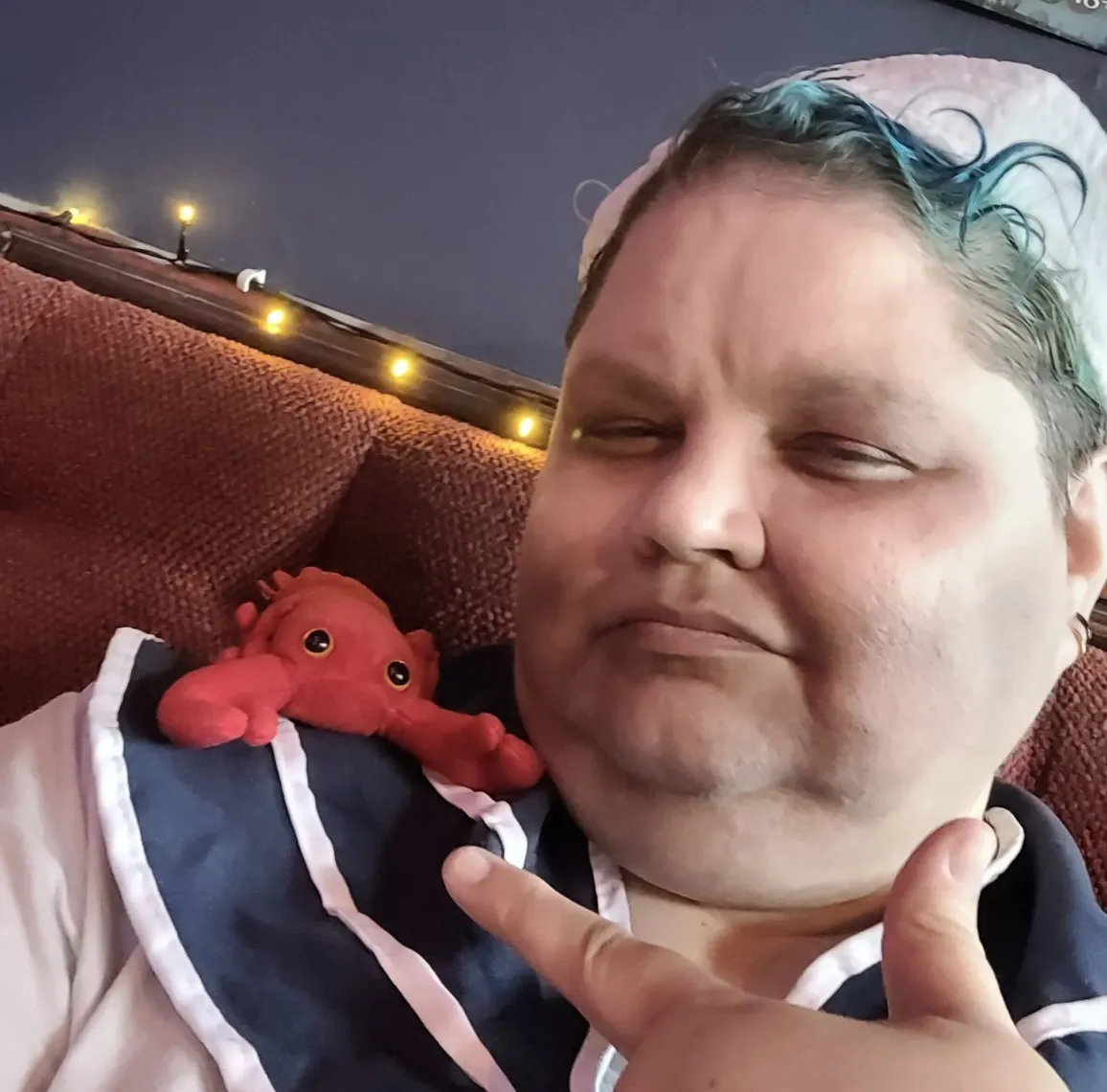 Sandy Bawls, unable seaman, looking like he's been on a 10-week bender, pointing at his lobster