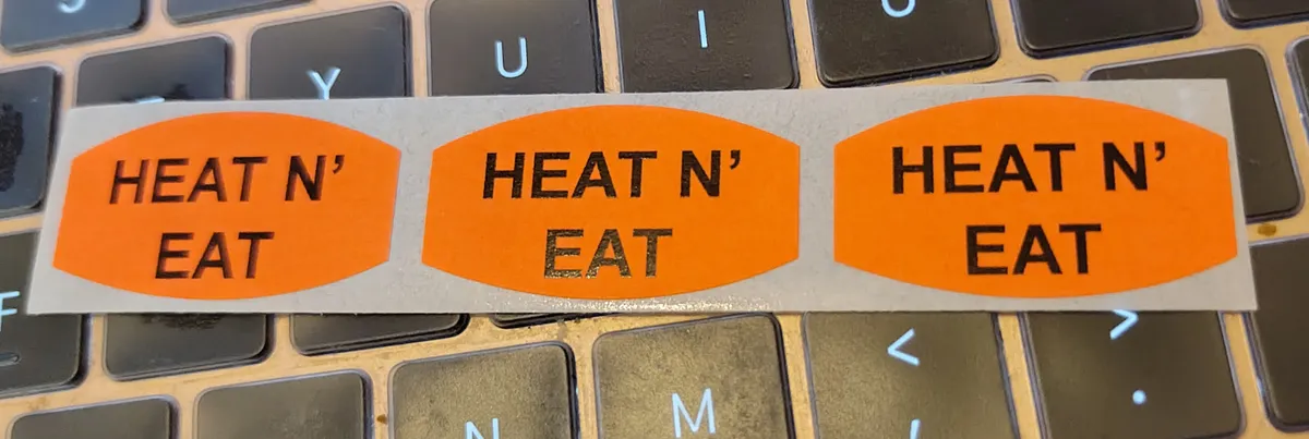 Three bright orange oval stickers that say HEAT N' EAT on them