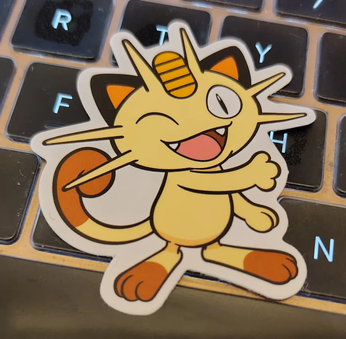 Meowth is winking towards us